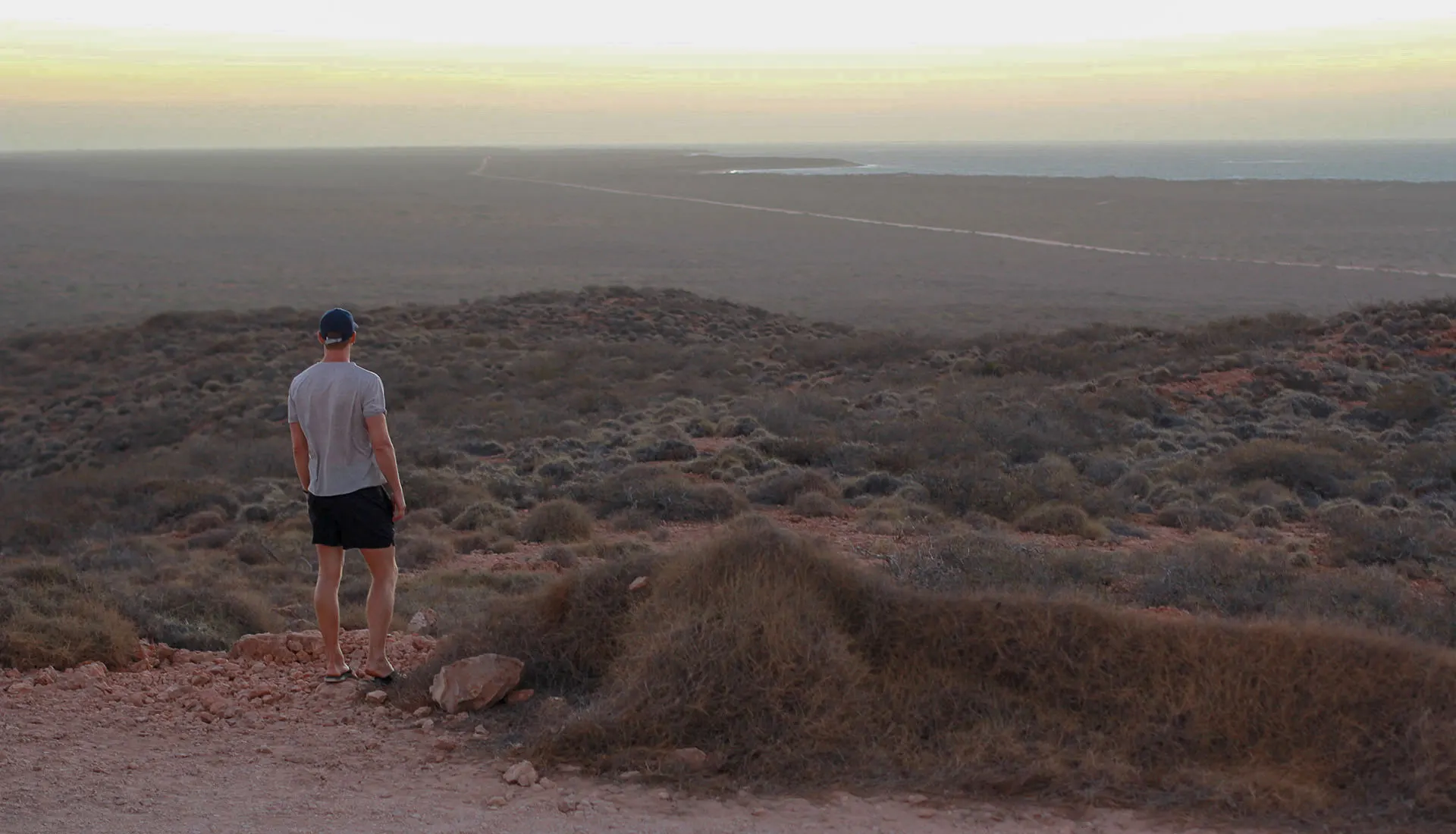 Looking out over red desert to the sea