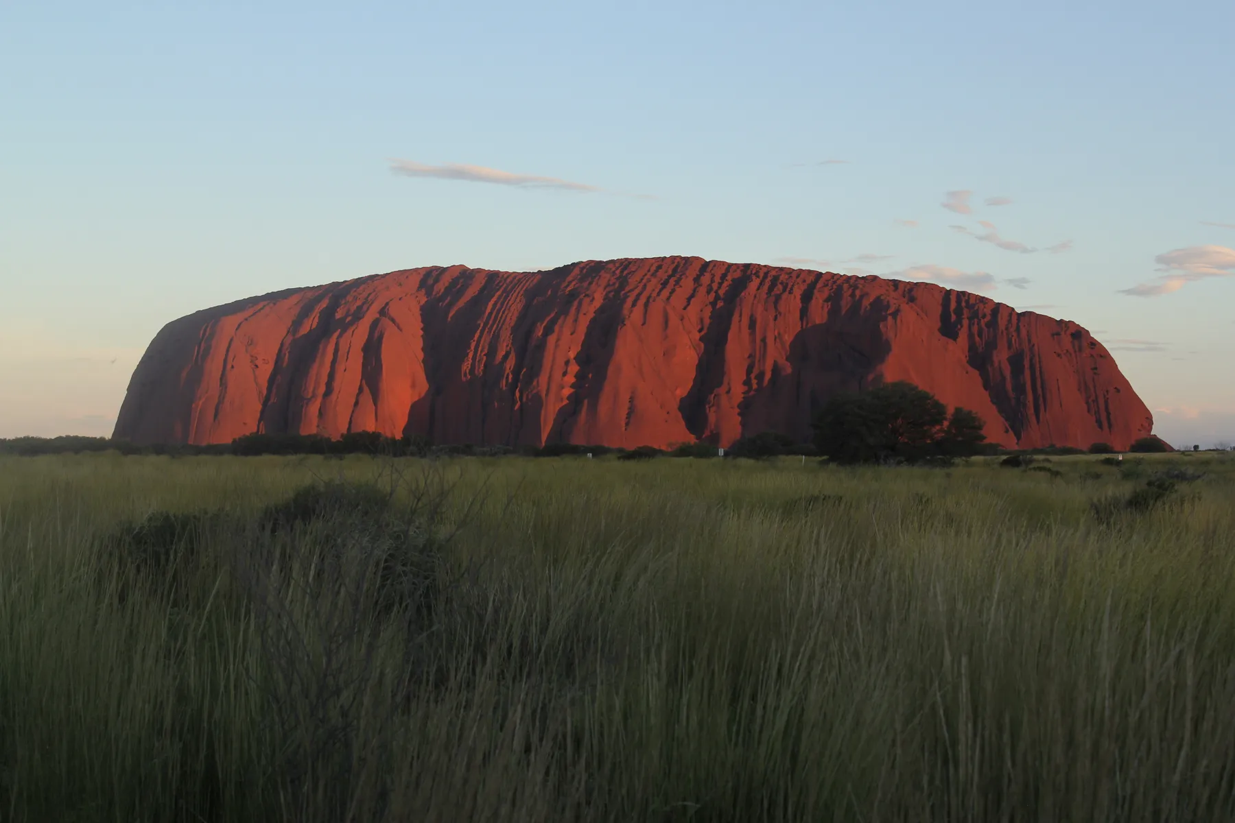 Uluru glowing red at sunset